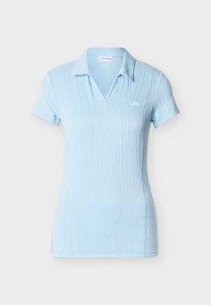 Light blue polo shirt with a v-neck, short sleeves, and vertical pattern lines. Features a small logo on the left chest. Soft, smooth texture.