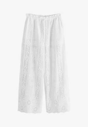 Hvide bukser med vide ben med lodrette blonder med blomsterpaneler og bølgede kanter, med elastisk talje og snøre foran.