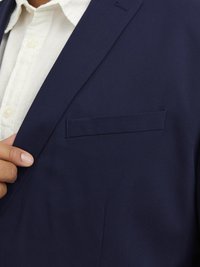 Navy blazer made of smooth, solid fabric; features a notched lapel, a chest pocket, and a sleek, tailored fit.