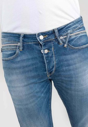 Jeans in denim blu con una vestibilità classica, dotati di chiusura con zip e bottone, cinque tasche e leggere sfumature per texture.