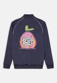 Dark blue jacket with a colorful cartoon character wearing a green cap and a message saying "Together we can change the world" on the back.