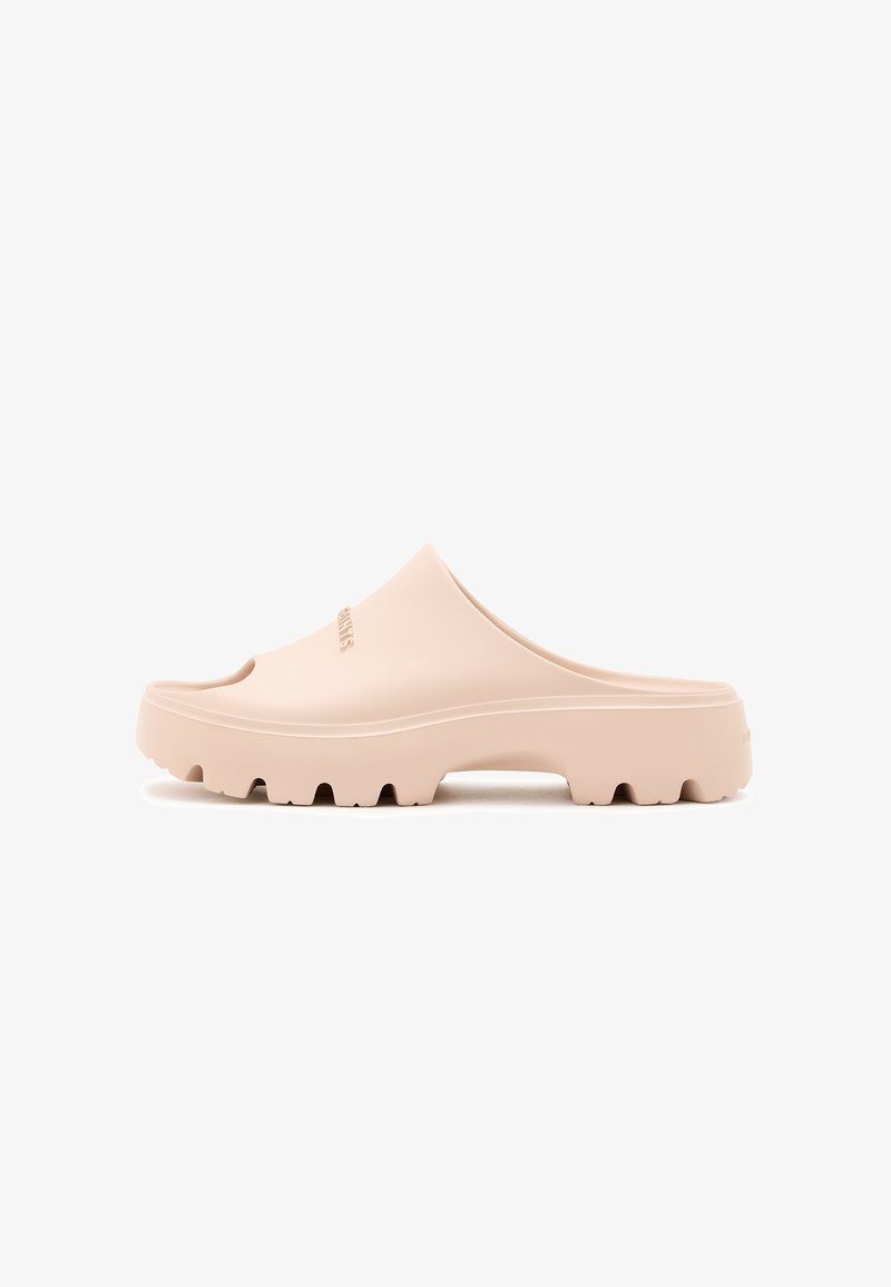 Light pink rubber slide sandal with a rounded slip-on design, textured sole, and wide strap featuring a subtle logo detail.