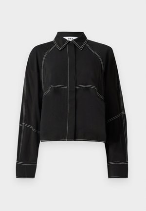 Black cropped shirt with long sleeves, featuring white contrast stitching, a classic collar, and a button-down front design.