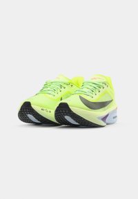 Neon yellow running shoes with mesh upper, black sole, and multicolored accents. Features flat laces and a streamlined design for performance.