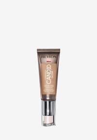 Revlon Candid Glow foundation i en 22 ml tub. Brun och silver förpackning med en pumpdispenser, märkt med produktinformation och nyansnummer.
