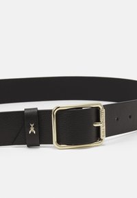 Cintura in pelle nera con fibbia in metallo dorato, finitura texturizzata e piccolo dettaglio decorativo a forma di ape sull'anello.