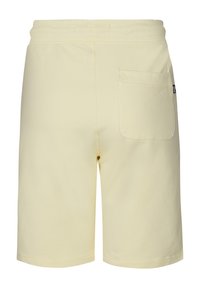 Lichtgele katoenen shorts met een elastische tailleband, voorzien van een enkele achterzak en een gladde, effen textuur.