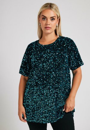 Haut noir couvert de sequins bleus, avec un col rond et des manches courtes, offrant une coupe décontractée et une surface texturée.