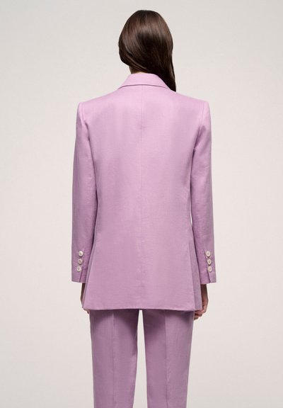 Lavender linen suit with a tailored blazer featuring a vented back and three-button cuffs, paired with straight-leg trousers.