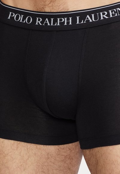 Boxeri scurți din bumbac negru, cu un design ajustat. Au un tiv elastic cu logo-ul "POLO RALPH LAUREN" în gri. Textură netedă, fără modele.