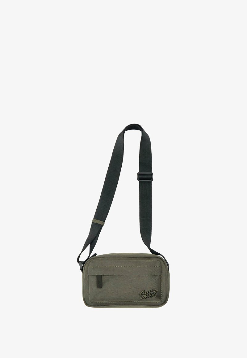 Olivgrüne Schultertasche aus strukturiertem Stoff, mit abnehmbarem Tragegurt, Reißverschlusstasche und Nähedetails.