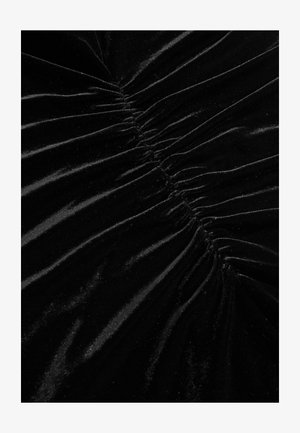 Fekete bársony textile, amely gyűrt textúrával, függőleges ráncolással, sima felülettel és finom fényességgel rendelkezik. Ideális elegáns ruhákhoz.