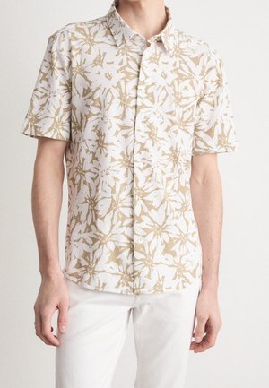 Chemise à manches courtes en tissu léger avec un motif floral beige et blanc, fermeture à boutons et col classique.