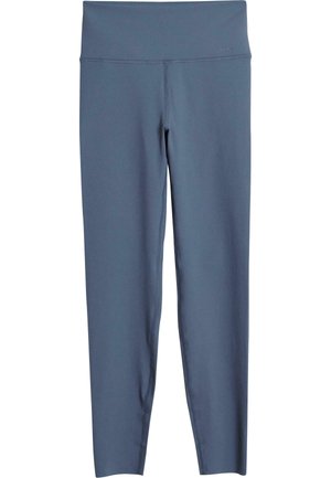 Tights laget av mykt, elastisk stoff i en dempet blåfarge. Har høy midje og minimale sømdetaljer. Skreddersydd passform til ankelen.