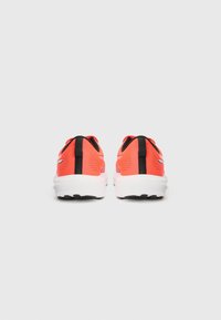 Red and black athletic shoes featuring a textured upper, white midsole, and black outsole, viewed from the back.