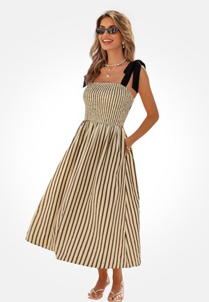 Sukienka midi bez ramiączek z marszczonym górnym stanem, z pionowymi beżowo-brązowymi paskami. Posiada czarne wiązane ramiączka oraz kieszenie.