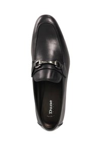 Black leather slip-on shoe featuring a rounded toe, smooth finish, subtle stitching, and a decorative metallic buckle accent.