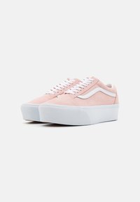 Pink suede sneakers with white accents, textured toe cap, contrasting laces, and a thick white rubber sole. Classic low-profile design.