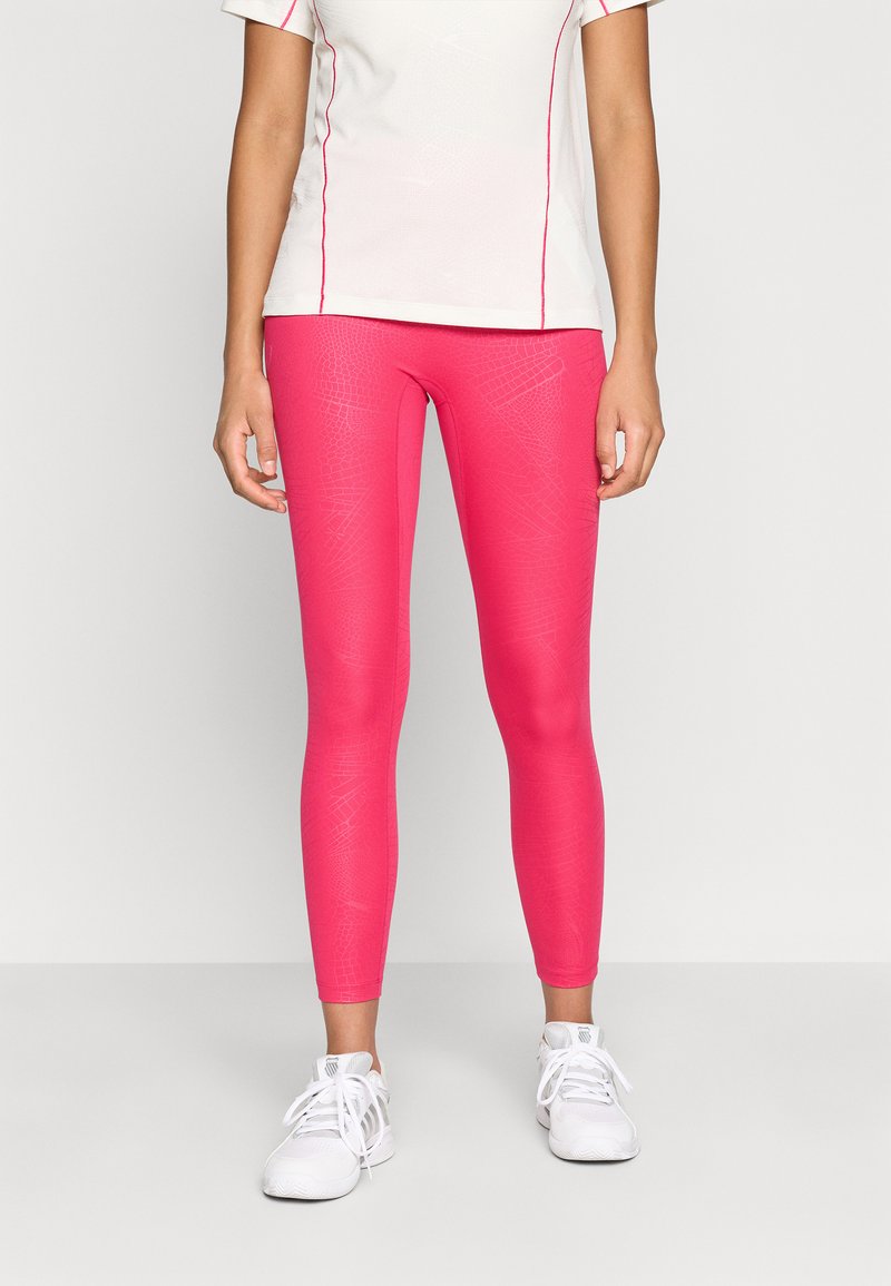 Tight-fitting leggings in bright pink with a textured pattern. Matched with a white short-sleeve top featuring pink accents.