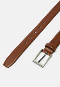 Brown leather belt with a smooth texture, tapered end, and silver rectangular buckle. Features evenly spaced holes for adjustment.
