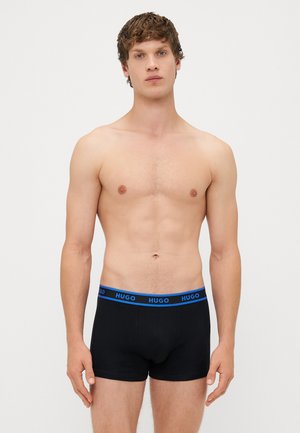 Boxer-briefs en coton noir avec une ceinture bleue comportant le logo "HUGO". Texture lisse, design ajusté, longueur jusqu'au milieu de la cuisse.