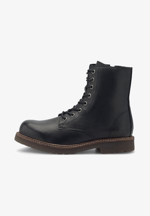 Bottine en cuir noir avec semelle cousue marron, fermeture éclair à l'avant et bout rond, présentée en profil latéral sur fond blanc.