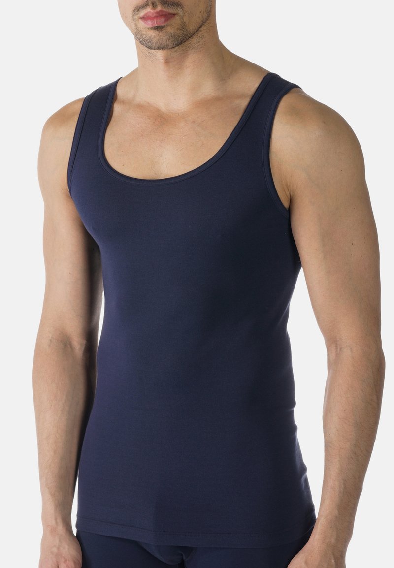 Navy tank top made of smooth, stretchy fabric with wide straps and a rounded neckline, featuring a fitted silhouette and minimal seams.
