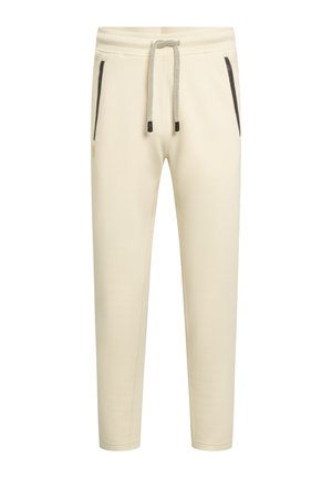 Sahnefarbene, schmal zulaufende Jogginghose mit Kordelzug an der Taille und schwarzen Reißverschlusstaschen auf beiden Seiten.