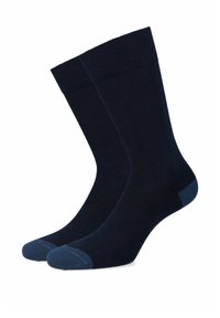 Granatowe skarpetki o gładkiej strukturze, z ryflowanymi mankietami i kontrastującymi akcentami w jaśniejszym odcieniu niebieskiego na palcach i piętach.