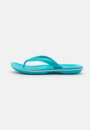 Turquoise flip-flop made of rubber with a textured footbed, thin straps, and a white accent line along the sole.