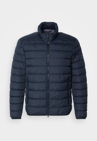 Navy blue puffer jacket with horizontal stitching, high collar, front zipper, and zippered side pockets. Made from lightweight, insulated material.