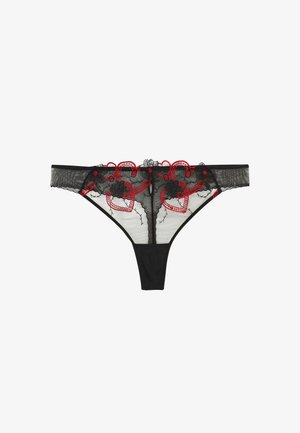 String noir en dentelle transparente avec des cœurs rouges brodés et des motifs floraux sur la ceinture avant.