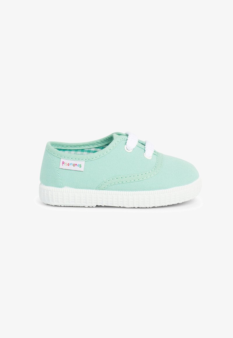 Světle zelená plátěná bota s bílou gumovou podrážkou a tkaničkami, se malým štítkem na boku. Hladký povrch a klasický tvar tenisky.