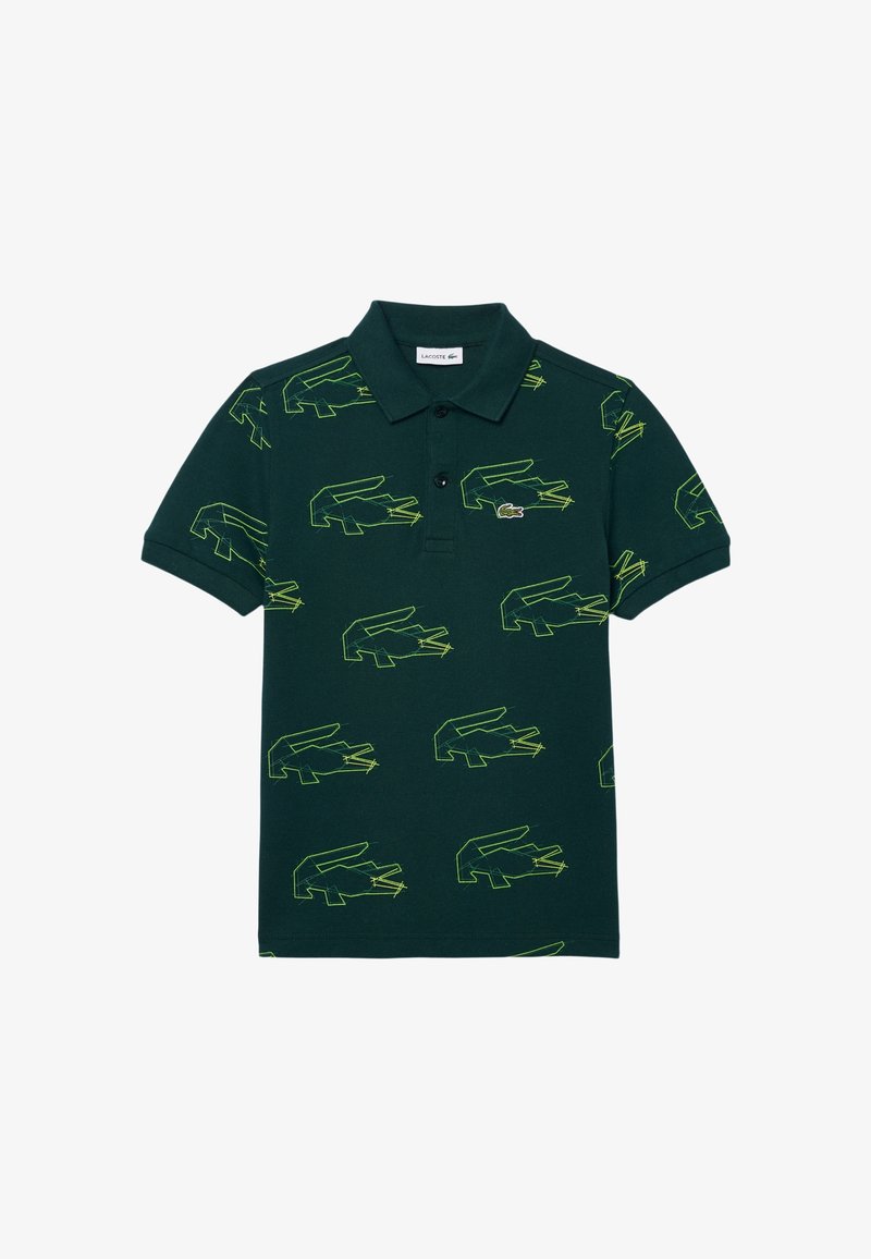Polo vert foncé avec col plié et patte de boutonnage, orné de logos crocodile en néon vert répétés en contour et d'un petit écusson crocodile brodé.