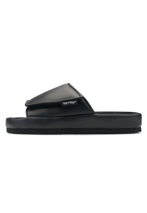 Black slide sandals with a padded upper and a textured sole, featuring a flap design and a small brand logo tag on the side.