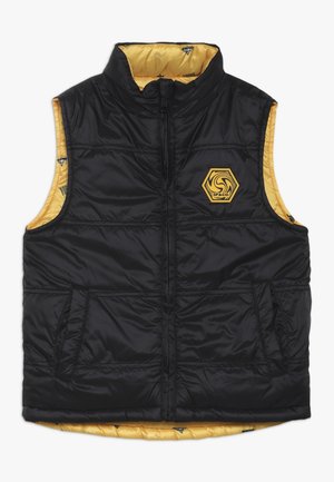 Smanicato nero trapuntato senza maniche con cerniera frontale, tasche laterali, fodera interna gialla e logo esagonale giallo sul petto.