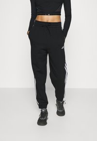 adidas Sportswear ESSENTIALS 3-STRIPES LOOSE-FIT - Spodnji deli trenirk - black/white