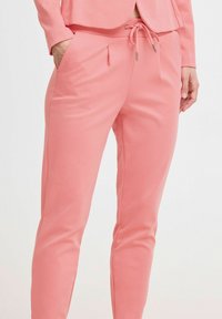 Rosa Sweatpants aus weichem, strukturiertem Stoff. Mit einem Kordelzugbund, seitlichen Taschen und einer taillierten Passform.