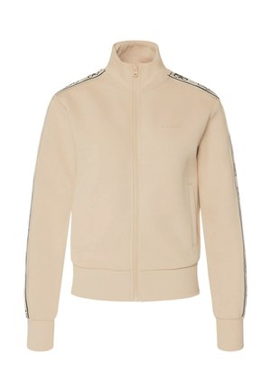 Giacca beige con cerniera realizzata in tessuto morbido, caratterizzata da un colletto alto, polsini e orlo a coste, con dettaglio logo e strisce laterali a contrasto.