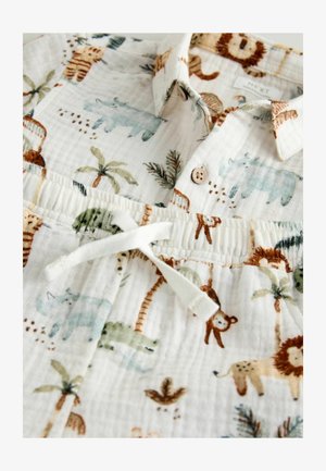 Bavlnená košeľa s krátkym rukávom a gombíkovým golierom, s bielym pozadím a farebnými vzormi zvierat a palmových stromov. Súčasťou je šnúrka v páse.