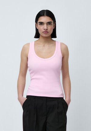 Débardeur rose à côtes avec un col rond et des bretelles larges, présentant une silhouette ajustée et un petit logo au niveau de l'ourlet.