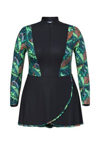 Maillot de bain à manches longues avec un corps noir, présentant des motifs de feuilles tropicales vertes et marron sur les bras et les côtés. Inclus une fermeture éclair à l'avant et une jupe.