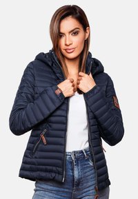 Navy puffer jacket with a zip front, attached hood, and ribbed cuffs. Features horizontal quilting and faux leather accents on sleeves.