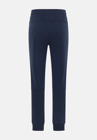 Marineblaue Jogginghose mit breitem Gummibund, gerippten Bündchen und einem dezenten Logo auf dem linken Bein. Glatte Oberfläche im gesamten Bereich.