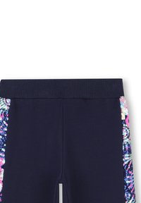 Leggings blu navy con una vita alta e dettagli in paillettes colorate sui lati in un motivo floreale, tessuto morbido.