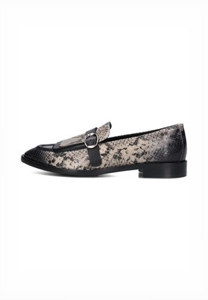 Flat loafers in black and beige snake print, featuring a round toe, decorative fringe, and a circular buckle accent on a smooth leather strap.