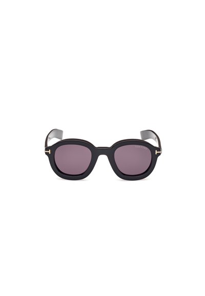 Lunettes de soleil noires avec des verres ovales, teinte violette et une épaisse monture. Présente des accents en or et un design élégant.