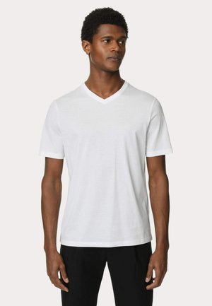 T-shirt en coton blanc à manches courtes et à col en V. Texture lisse, détails de couture minimaux et coupe décontractée.