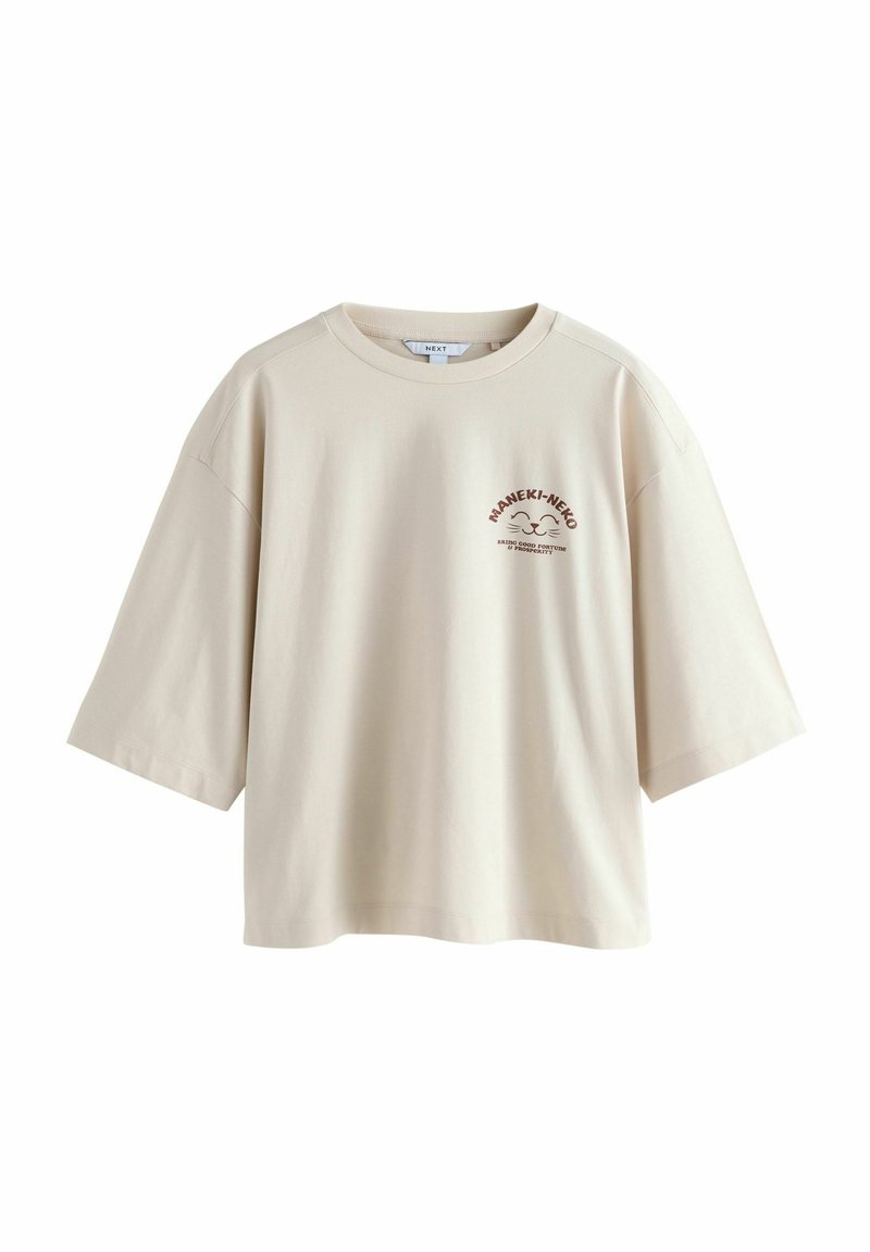 Beige oversized t-shirt i bomull med korta ärmar, med en tryckt logotypdesign i mörkbrunt på framsidan. Rund halsringning, avslappnad passform.