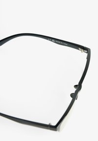 Black rectangular eyeglasses with metallic accents. Features thick arms, a minimalistic design, and transparent lenses. Marked 'Made in China.'